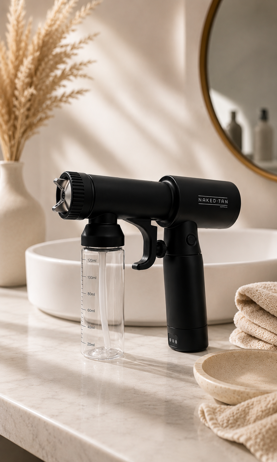 Naked Tan ProMist Mini portable spray tan machine with Luxe rapid tan solution in modern bathroom setting